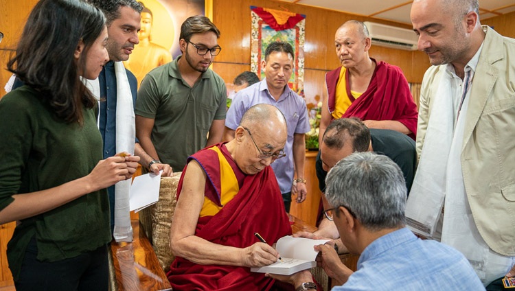 Su Santidad el Dalái Lama firma uno de sus libros para presentarlo a los miembros del Club de Impacto Iraní al término de su reunión en su residencia de Dharamsala, HP, India, el 7 de junio de 2019. Foto de Tenzin Choejor