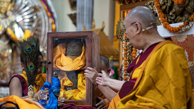 Su Santidad el Dalái Lama señalando una vitrina que contenía piezas de una estatua de Avalokiteshvara destruida durante la revolución cultural, pero que más tarde fue rescatada y traída a la India mientras explicaba el Empoderamiento de Avalokiteshvara en el Templo Principal Tibetano en Dharamsala, HP, India, el 5 de junio de 2019. Foto de Tenzin Choejor